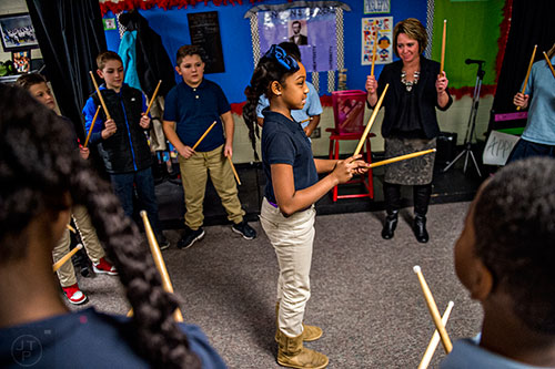 Taiydaum Thompson (center) leads her classmates in counting out the sides of a polygon using drumsticks during class at Powder Springs Elementary School in Powder Springs on Thursday, January 28, 2016. 