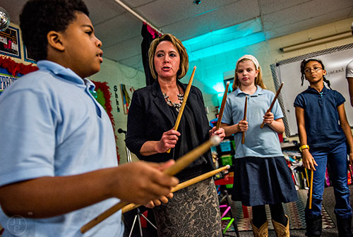 Fifth grade teacher Nikki Clotfelter (center) talks with Sean Cobb and the rest of her class about how to use music to help with math problems at Powder Springs Elementary School in Powder Springs on Thursday, January 28, 2016. 