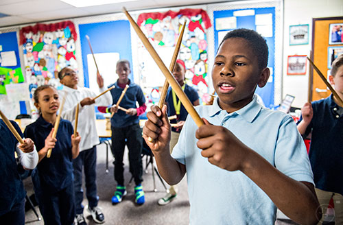 Harry Tucker (center) leads his classmates in counting out the sides of a polygon using drumsticks during class at Powder Springs Elementary School in Powder Springs on Thursday, January 28, 2016. 
