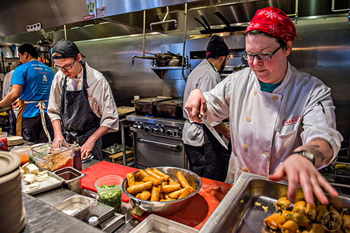 Courtney Adams (right) and Jeff Bell prepare food during the Lunar New Year Celebration at Makan in Decatur on Saturday, February 6, 2016.