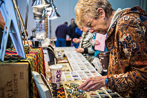 Sandy Azzarello (right) checks out the different beads for sale during the Intergalactic Bead Show at the Infinite Energy Center in Duluth on Saturday, February 6, 2016.