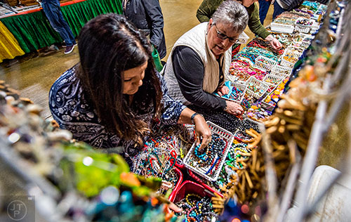 Gina Smith (left) and Vicky O'Bonnon check out the different beads for sale during the Intergalactic Bead Show at the Infinite Energy Center in Duluth on Saturday, February 6, 2016. 