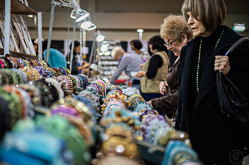 Elise Hughes (right) checks out the different beads for sale during the Intergalactic Bead Show at the Infinite Energy Center in Duluth on Saturday, February 6, 2016. 