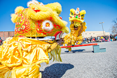 Chris Lu (right) performs a traditional lion dance with his partners during the Atlanta Chinese Lunar New Year Festival in Chamblee on Saturday, February 13, 2016. 