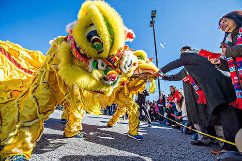 People give envelopes filled with money to the lion performers during the Atlanta Chinese Lunar New Year Festival in Chamblee on Saturday, February 13, 2016. 