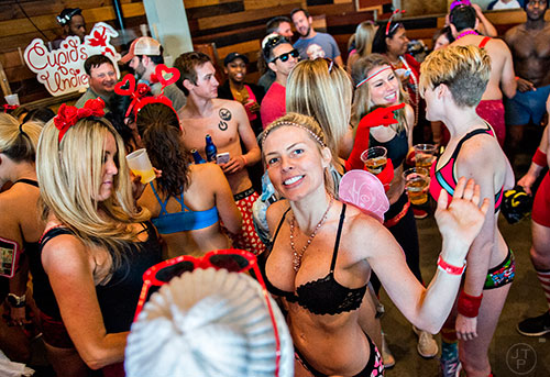 Daphne Joslyn (center) dances as a deejay spins tunes before the start of the 2016 Cupid Undie Run at Big Sky in Buckhead on Saturday, February 13, 2016. 
