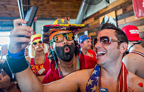 Dressed as Elvis, Ryan Eversley (right) takes a selfie with a Macho Man Savage dressed Jon Fisher before the start of the 2016 Cupid Undie Run at Big Sky in Buckhead on Saturday, February 13, 2016. 