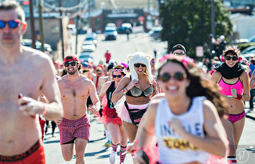 Ria Kirk (center) runs up Cains Hill Pl. during the 2016 Cupid Undie Run in Buckhead on Saturday, February 13, 2016. 