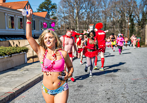 February 13, 2016 Atlanta - Courtney Heba (left) nears the end of the 2016 Cupid Undie Run in Buckhead on Saturday, February 13, 2016. Around 800 runners registered for the fifth annual event which raised $250,000 for neurofibromatosis research. JONATHAN PHILLIPS / SPECIAL