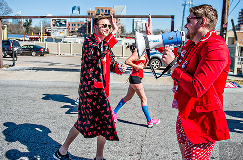 February 13, 2016 Atlanta - Chad Leathers (right) yells into a bullhorn as runners near the end of the 2016 Cupid Undie Run in Buckhead on Saturday, February 13, 2016. Around 800 runners registered for the fifth annual event which raised $250,000 for neurofibromatosis research. JONATHAN PHILLIPS / SPECIAL