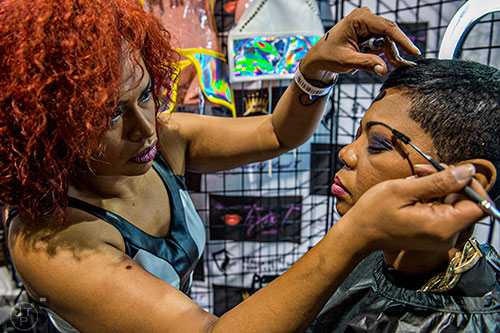 Kathia Santana (left) applies makeup for Toylesha Thomas during the Bronner Brothers International Beauty Show at the Georgia World Congress Center in Atlanta on Saturday, February 20, 2016.