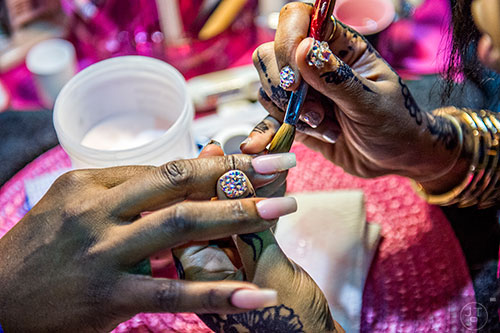 Kiea Taylor (right) works on Kimberly Taylor-Green's nails during the Bronner Brothers International Beauty Show at the Georgia World Congress Center in Atlanta on Saturday, February 20, 2016.