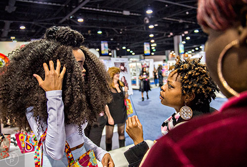 Monique Kelly (right) talks to Maryum Rabia about her hair during the Bronner Brothers International Beauty Show at the Georgia World Congress Center in Atlanta on Saturday, February 20, 2016.
