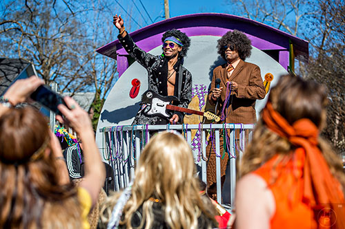 Katarro Rountree (left) and Dennis Ruffin throw beads to the crowd during the first annual LantaGras Parade in Kirkwood on Saturday.
