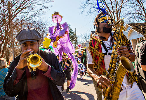 Wolfpack ATL's Dashill Smith (left) and Kebbi Williams play music as they march in the first annual LantaGras Parade in Kirkwood on Saturday. Photo: Jonathan Phillips
