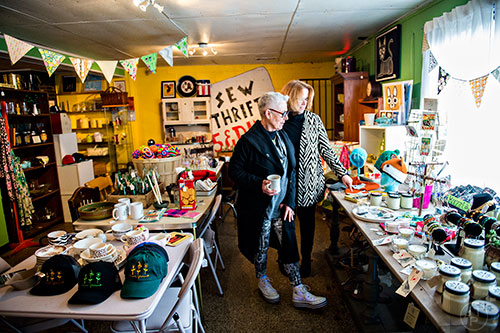 Francoise Wolfe (left) and JoEllen Wolicki peruse the items for sale in the thrift store section at Home grown off of Memorial Drive in Atlanta.