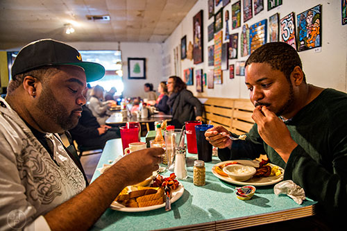 Zilton Lawson (left) and Jason Fairbanks eat breakfast at Home grown off of Memorial Drive in Atlanta.
