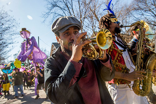 Wolfpack ATL's Dashill Smith (left) and Kebbi Williams play music as they march in the first annual LantaGras Parade in Kirkwood on Saturday.