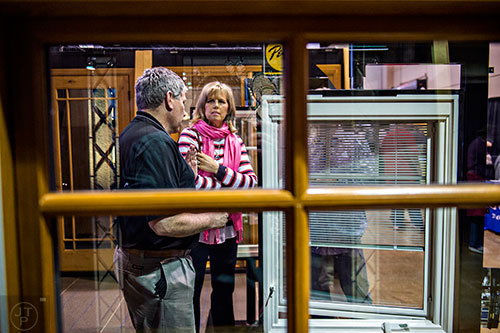 Wayne Rowan (left) talks to Vickie Jennings about windows during the North Atlanta Home Show at the Infinite Energy Center in Duluth on Saturday, February 20, 2016. 