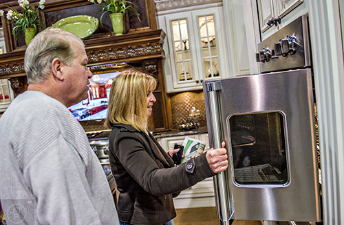 JoAn Adams (center) and her husband Greg look at an oven during the North Atlanta Home Show at the Infinite Energy Center in Duluth on Saturday, February 20, 2016. 