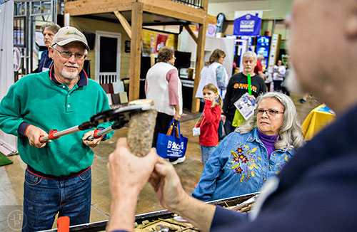Rick January (left) learns to use a ratchet lopper as his wife Stella watches during the North Atlanta Home Show at the Infinite Energy Center in Duluth on Saturday, February 20, 2016.