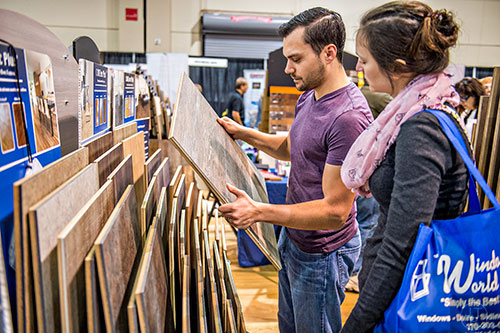 Joshua Dimmig-Russell (center) and his wife Jessica look at flooring during the North Atlanta Home Show at the Infinite Energy Center in Duluth on Saturday, February 20, 2016.