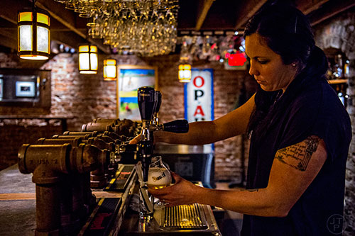 Jessica Bilz pours a beer at Brick Store Pub in Decatur on Tuesday, February 23, 2016. Brick Store has been a Decatur staple since it opened in 1997. 
