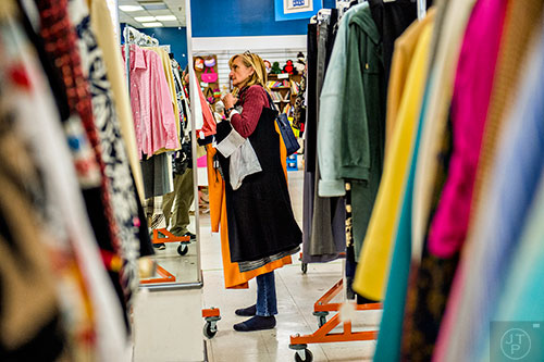Laurie Jeffay (center) shops for clothes during the 25th annual Sandy Springs Society Tossed Out Treasures sale at Marshall's Plaza in Sandy Springs on Saturday, February 27, 2016. 