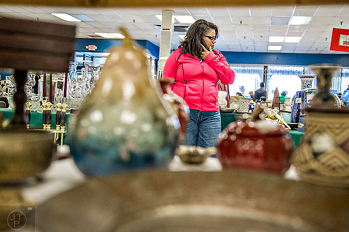 Phyllis Sawyer (center) shops during the 25th annual Sandy Springs Society Tossed Out Treasures sale at Marshall's Plaza in Sandy Springs on Saturday, February 27, 2016. 