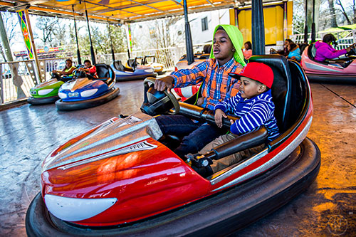 Justice Bradley (right) and Jathan Bradley ride the bumper cars at the Atlanta Fair near Turner Field in downtown on Saturday, February 27, 2016. 