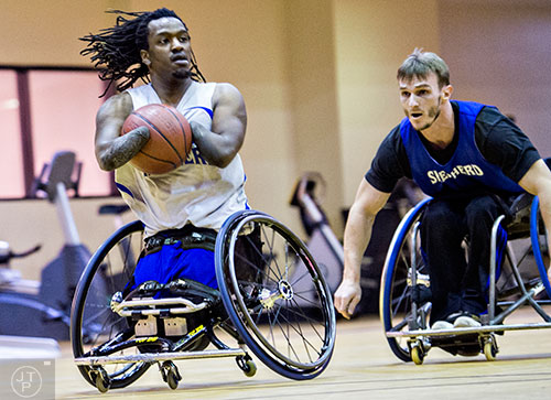 James Adams (left) dribbles the ball down the court as he is chased by Samir Jusupovic during basketball practice at the Shepherd Center in Atlanta on Thursday, February 25, 2016. 