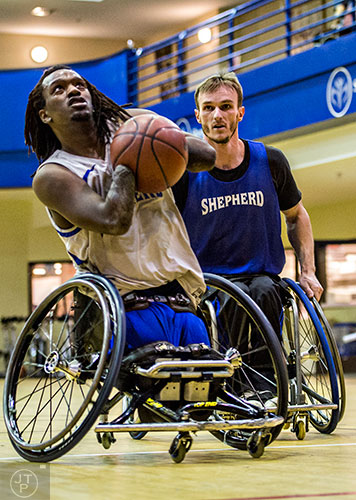 James Adams (left) goes in to try and shoot as he is chased by Samir Jusupovic during basketball practice at the Shepherd Center in Atlanta on Thursday, February 25, 2016. 