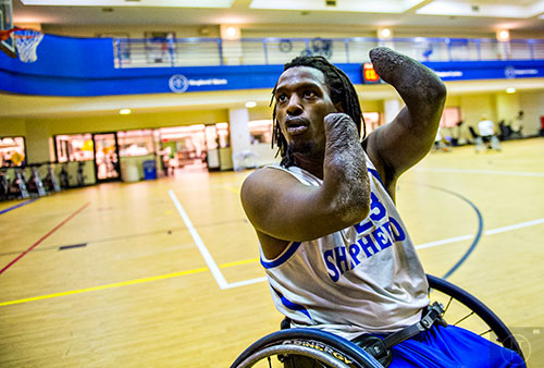 James Adams talks about using his arm to lead the ball to the basket during a quick break in basketball practice at the Shepherd Center in Atlanta on Thursday, February 25, 2016. 