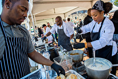 Dionte Dillard (left), Melody Conner (right) and Anthony Sanders serve up brunch with the Atlanta Breakfast Club during the Atlanta Brunch Festival at Fourth Ward Park in Atlanta on Saturday, March 5, 2016. 