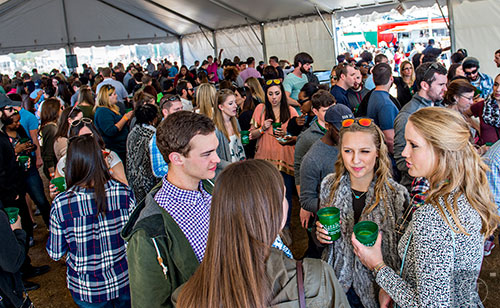 Caroline Harding (right) and Brian Hartnett hang out in the VIP tent during the Atlanta Brunch Festival at Fourth Ward Park in Atlanta on Saturday, March 5, 2016. 