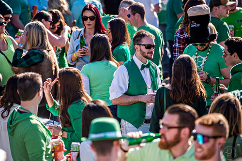 Surrounded by a sea of green, Matt Gohr (center) talks to friends during LepreCon at Park Tavern in Atlanta on Saturday, March 5, 2016. 