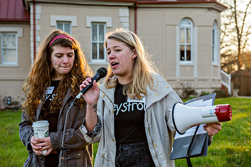 Sarah Norman (left) and Sara Stubbs, the organizers of the Rally for Riley, speak to a few hundred people gathered during the Rally for Riley across from Decatur High School on Monday morning.