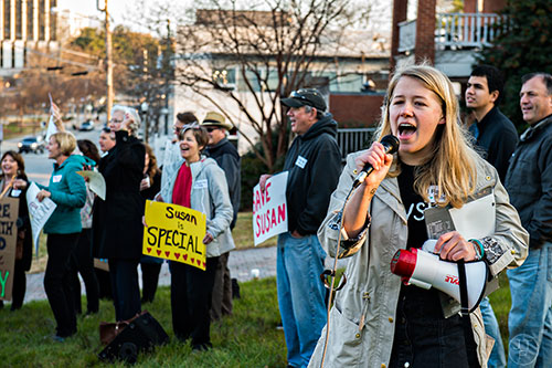 Sara Stubbs (right), one of the organizers of the Rally for Riley, leads the crowd gathered across from Decatur High School in support of Susan Riley in chants and cheers on Monday morning.