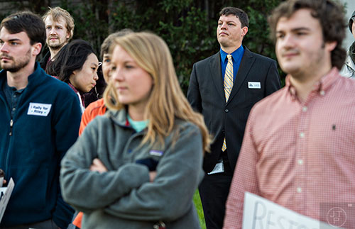 City Schools of Decatur Superintendent Dr. David Dude (center) listens to people speak during the Rally for Riley across from Decatur High School on Monday morning. Dude is reconsidering his decision to terminate Susan Riley, a popular media clerk at Decatur High School.