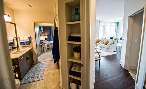The main entryway in the two bedroom model apartment at The High Rise at Post Alexander in Buckhead splits off to the guest bathroom and adjoining bedroom as well as the living room.