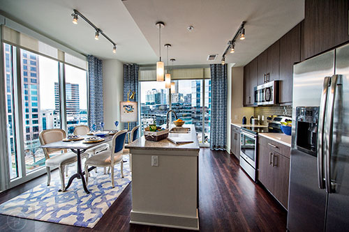 The kitchen and dining room in the two bedroom model apartment at The High Rise at Post Alexander in Buckhead.