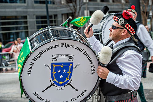 Atholl Highlanders Pipes & Drums' Roger Miller bangs on his bass drum during the annual Atlanta St. Patrick's Day Parade on Saturday, March 12, 2016. 