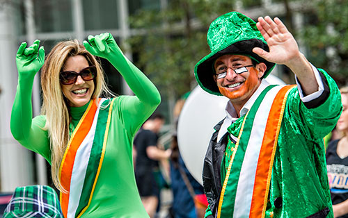 Grand Marshalls Q-100's Kristin and Bert wave to the crowd during the annual Atlanta St. Patrick's Day Parade on Saturday, March 12, 2016. 