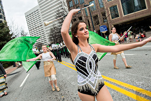 Carter High School's MaKenna Rayno (center) twirls her baton as she marches down Peachtree St. during the annual Atlanta St. Patrick's Day Parade on Saturday, March 12, 2016. 