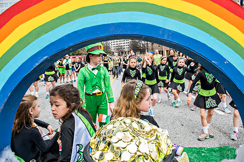 Dressed as a leprechaun, Tommy Brooks (left) marches down Peachtree St. during the annual Atlanta St. Patrick's Day Parade on Saturday, March 12, 2016. 