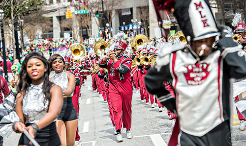 Martin Luther King High School's Malik Gordon (center) plays his trumpet as he marches down Peachtree St. during the annual Atlanta St. Patrick's Day Parade on Saturday, March 12, 2016. 