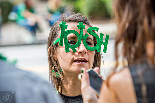 Christine O'Brien (center) talks to friends during the annual Atlanta St. Patrick's Day Parade on Saturday, March 12, 2016. 