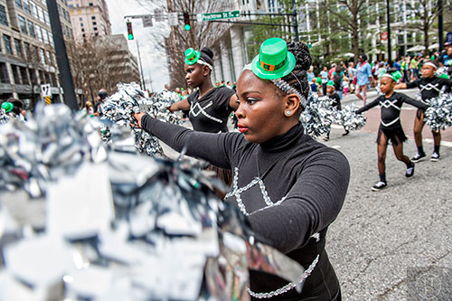 Naiya Bateman (center) dances her way down Peachtree St. during the annual Atlanta St. Patrick's Day Parade on Saturday, March 12, 2016. 