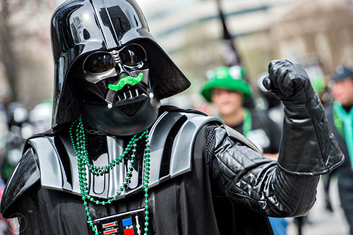 Dressed as Darth Vader, Jeff Grossmann marches down Peachtree St. during the annual Atlanta St. Patrick's Day Parade on Saturday, March 12, 2016. 