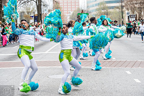Kelvin Harriss (left) and Ronald Gross dance their way down Peachtree St. during the annual Atlanta St. Patrick's Day Parade on Saturday, March 12, 2016. 